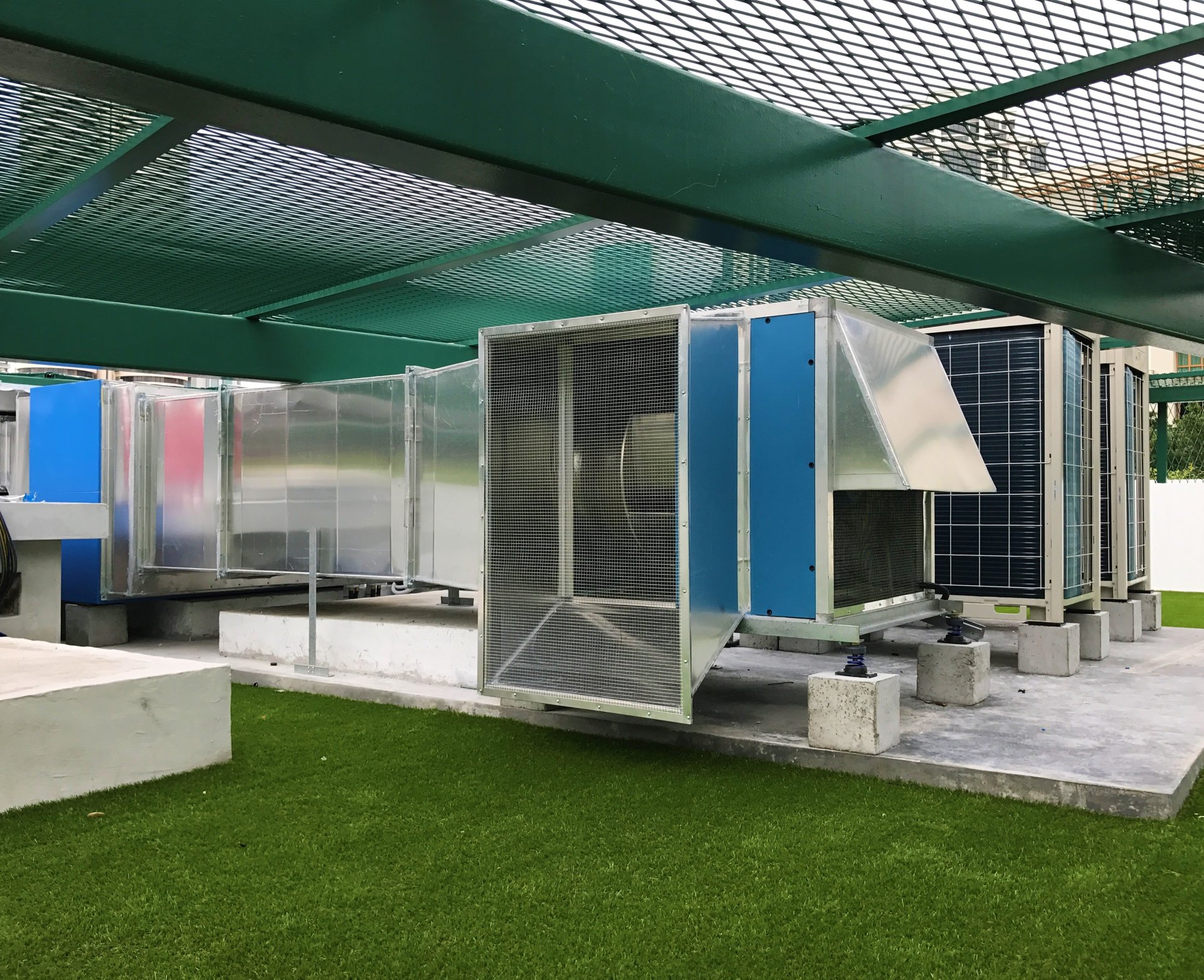Completed outdoor ACMV plant installation with ducting and condenser units