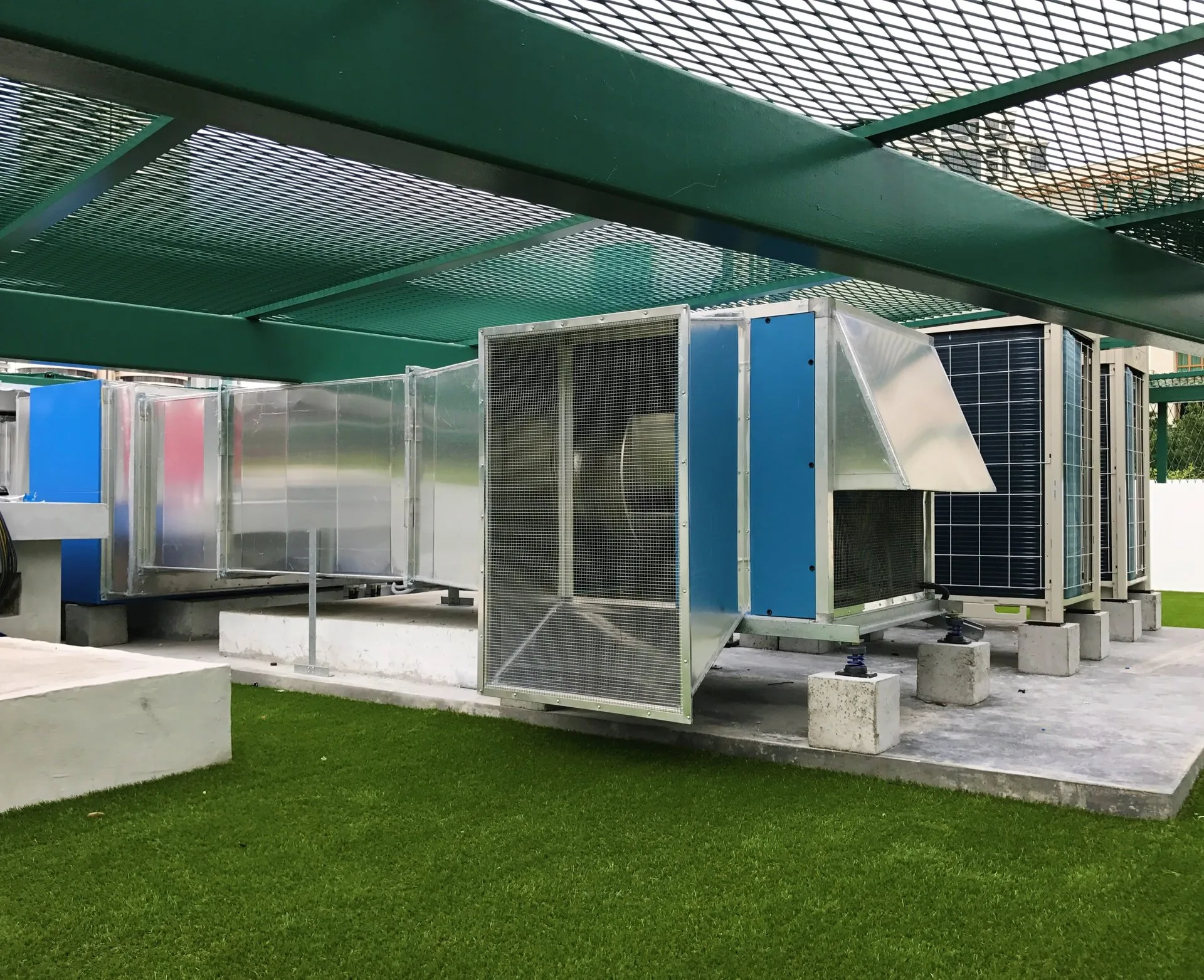 Completed outdoor ACMV plant installation with ducting and condenser units